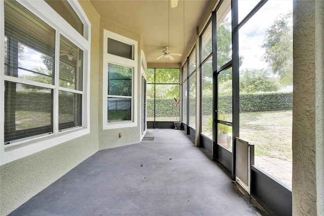 unfurnished sunroom with a wealth of natural light and ceiling fan