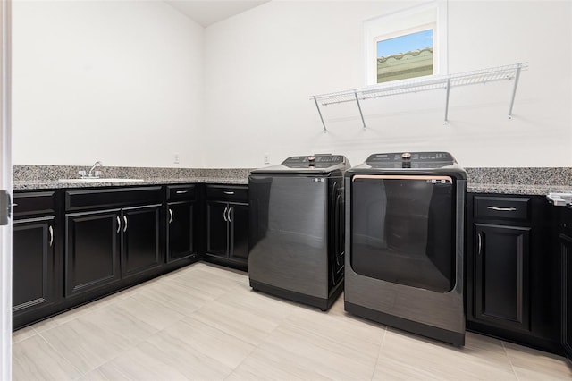 laundry area featuring cabinets, sink, and washing machine and clothes dryer