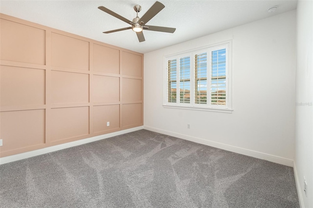 spare room featuring carpet flooring and ceiling fan