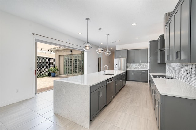 kitchen with stainless steel appliances, a large island, hanging light fixtures, and gray cabinetry