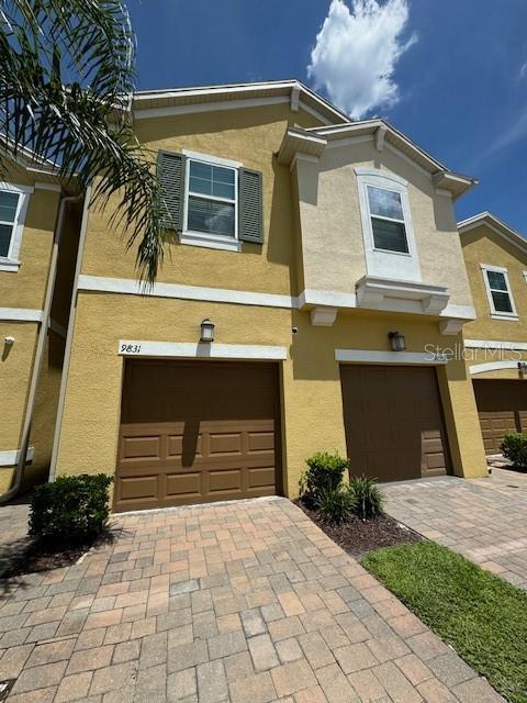 multi unit property with a garage and a wall unit AC