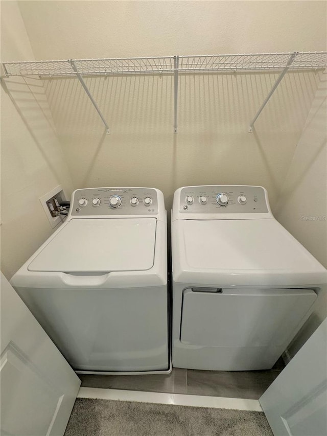 clothes washing area featuring separate washer and dryer