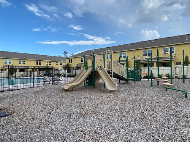 view of jungle gym featuring a community pool