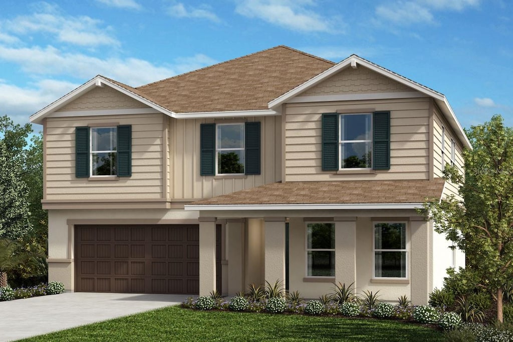 view of front of house featuring a garage and a front lawn