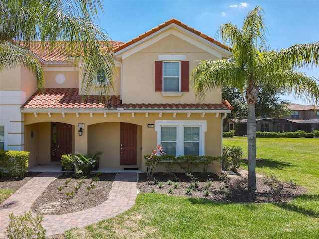 mediterranean / spanish-style home with a front yard