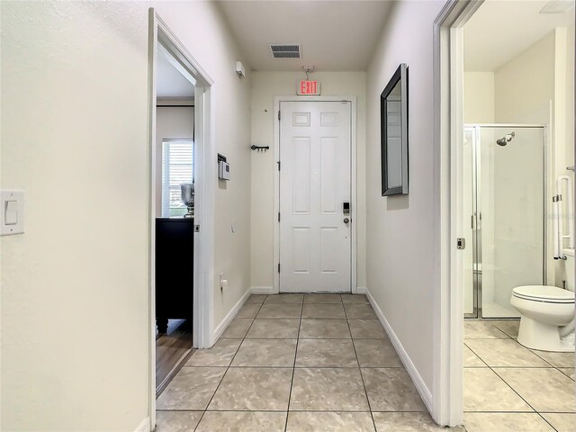 hallway featuring light tile patterned floors