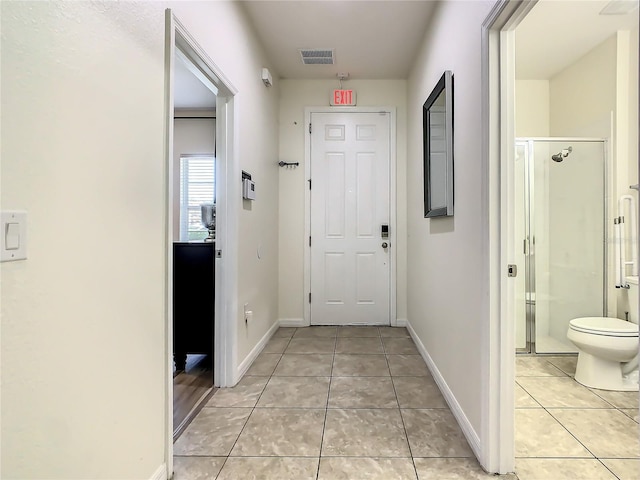 hall featuring light tile patterned flooring