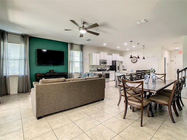 living room featuring light tile patterned floors and ceiling fan