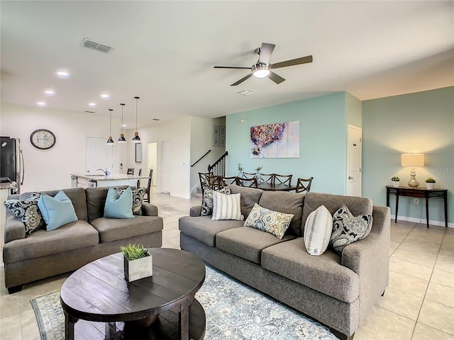 tiled living room with sink and ceiling fan