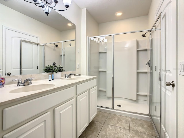 bathroom featuring tile patterned floors, a shower with shower door, and vanity