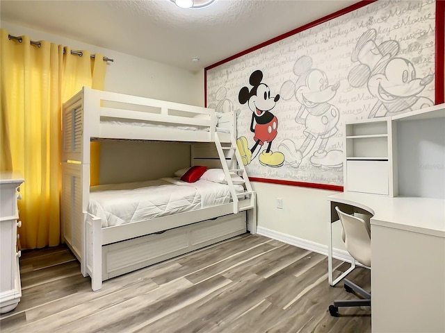 bedroom with hardwood / wood-style flooring and a textured ceiling