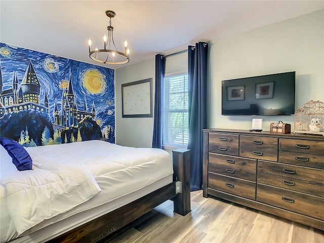 bedroom featuring an inviting chandelier and light wood-type flooring