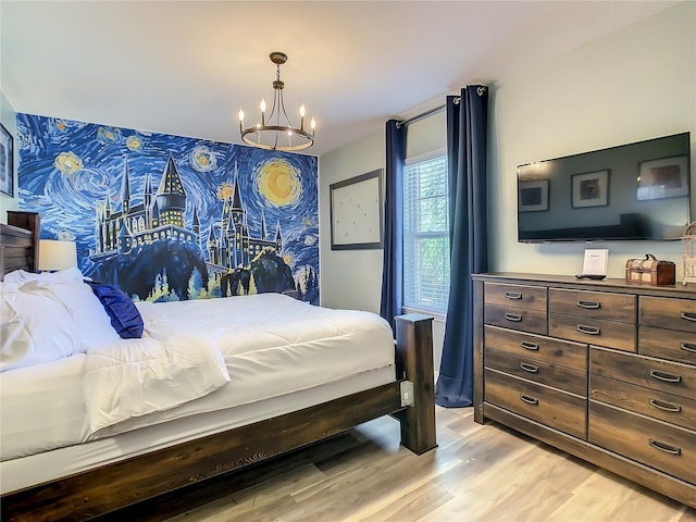 bedroom featuring light hardwood / wood-style floors and a chandelier