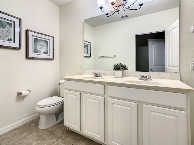 bathroom with tile patterned flooring, vanity, a chandelier, and toilet