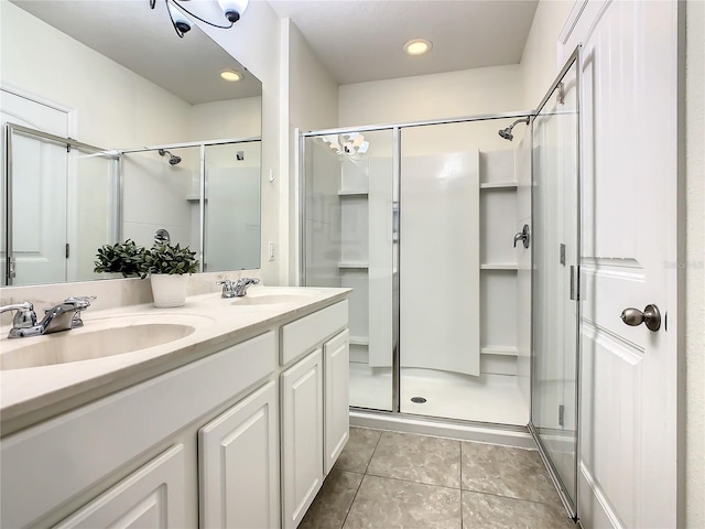 bathroom featuring vanity, tile patterned flooring, and a shower with door