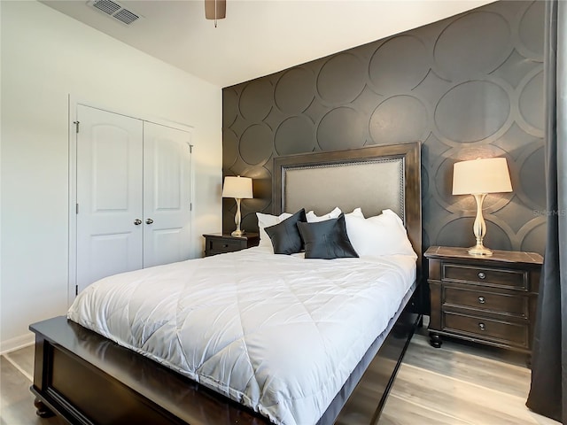 bedroom with a closet and light hardwood / wood-style flooring