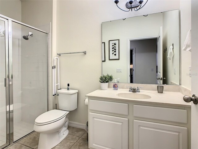 bathroom with vanity, tile patterned flooring, a shower with shower door, and toilet