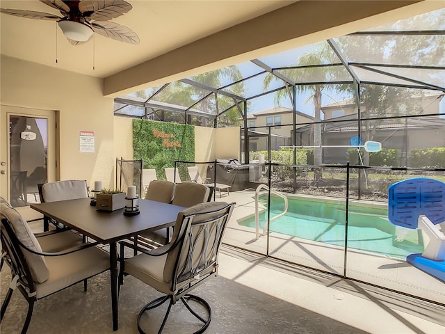 view of pool featuring a lanai, a patio area, and ceiling fan