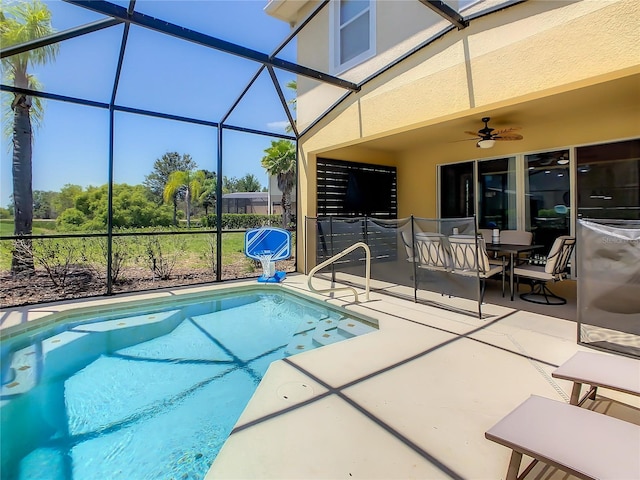 view of pool with ceiling fan, a patio, and glass enclosure