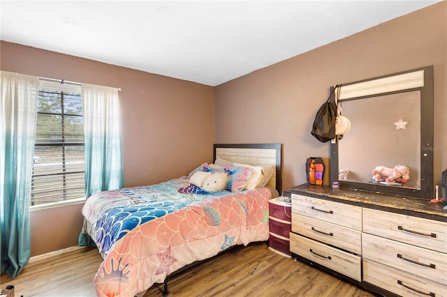 bedroom with hardwood / wood-style flooring