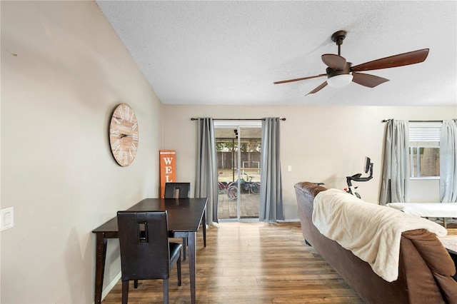 bedroom with a textured ceiling, ceiling fan, wood-type flooring, and access to outside