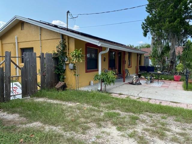 709 N Disston, Tavares, FL 32778 - rear view of property featuring stucco siding, a patio, and fence