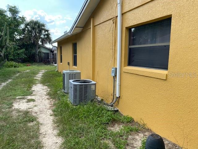 view of side of property featuring central air condition unit