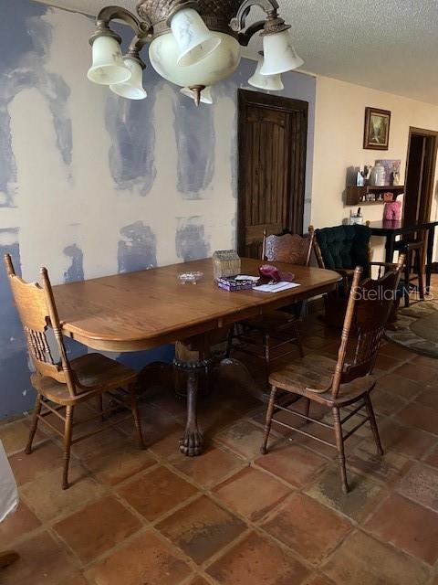 tiled dining area featuring a textured ceiling