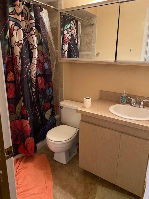 bathroom featuring tile patterned floors, toilet, and vanity