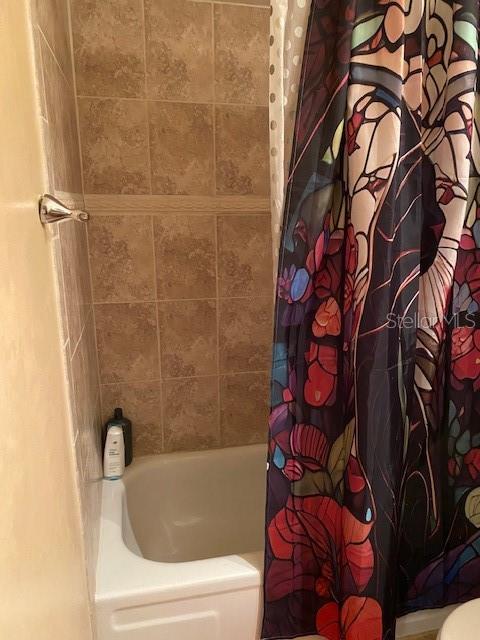 bathroom featuring shower / bath combination with curtain