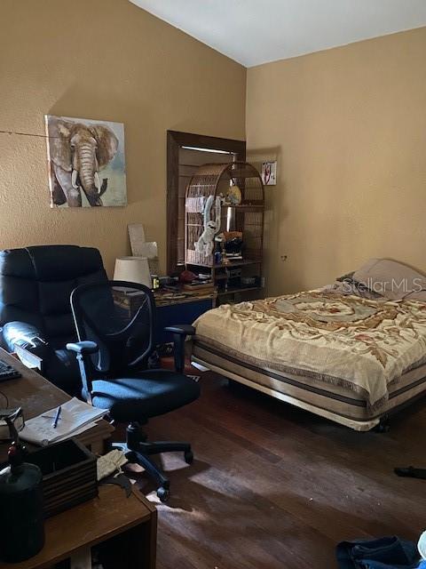 bedroom with wood-type flooring