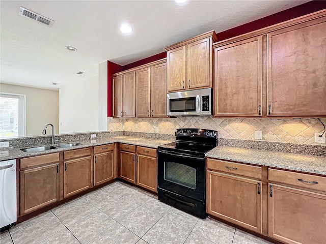 kitchen featuring decorative backsplash, dishwashing machine, black range with electric cooktop, sink, and light tile patterned floors