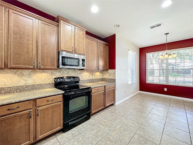 kitchen with hanging light fixtures, decorative backsplash, light tile patterned floors, black / electric stove, and light stone counters