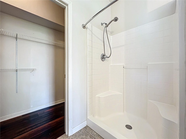 bathroom featuring tiled shower and hardwood / wood-style floors