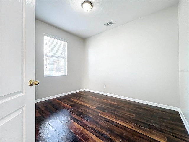 spare room featuring dark hardwood / wood-style floors