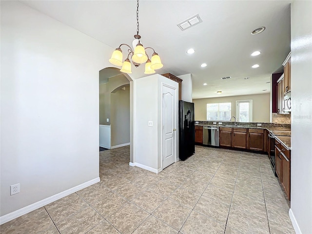 kitchen featuring sink, hanging light fixtures, an inviting chandelier, light tile patterned floors, and appliances with stainless steel finishes