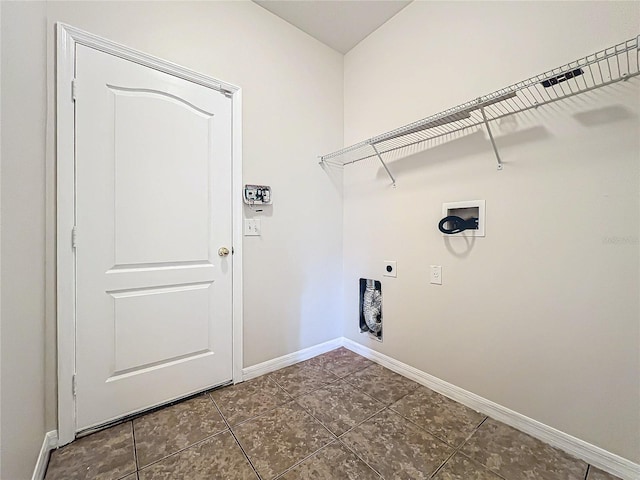 laundry room with hookup for an electric dryer, dark tile patterned flooring, and washer hookup