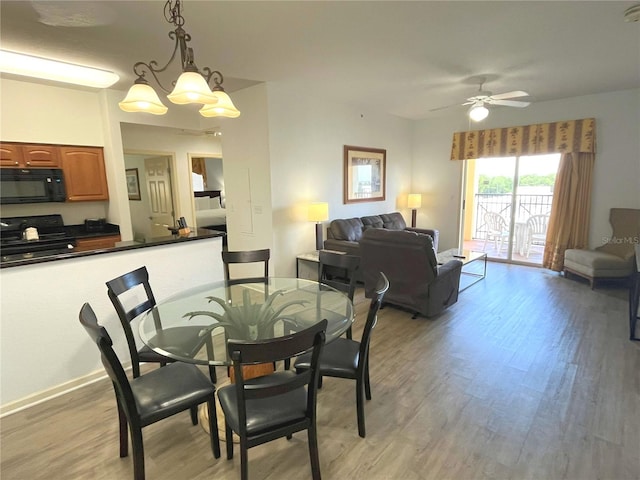 dining room with light wood-style floors and a ceiling fan