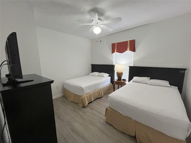 bedroom with light wood finished floors and a ceiling fan