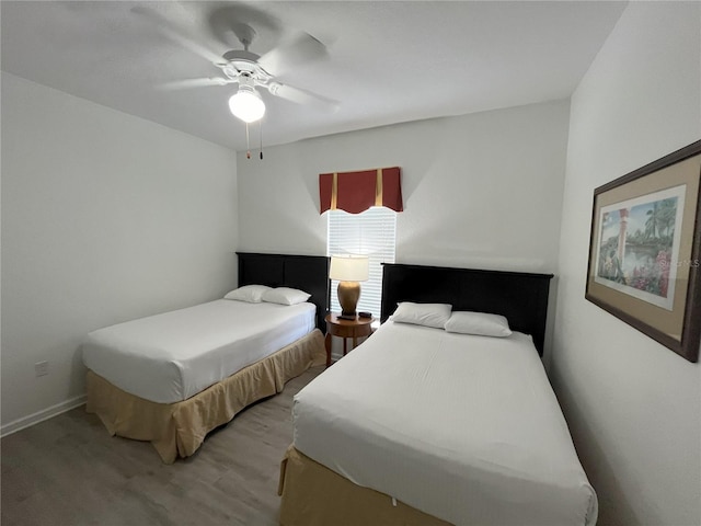 bedroom with wood finished floors and a ceiling fan