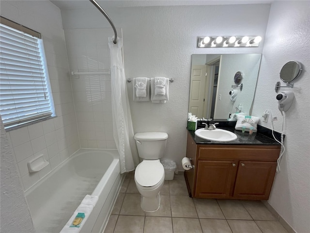 bathroom with shower / tub combo, baseboards, toilet, tile patterned floors, and vanity