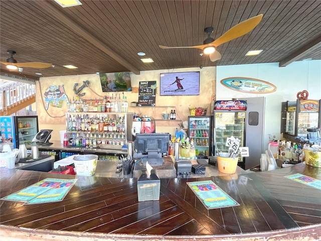 office space featuring wood ceiling, hardwood / wood-style floors, a ceiling fan, a bar, and beamed ceiling