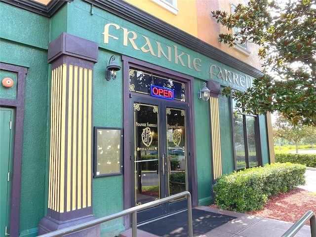 property entrance with stucco siding