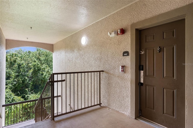 view of exterior entry with a balcony