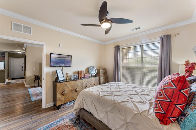 bedroom featuring wood-type flooring, crown molding, and ceiling fan