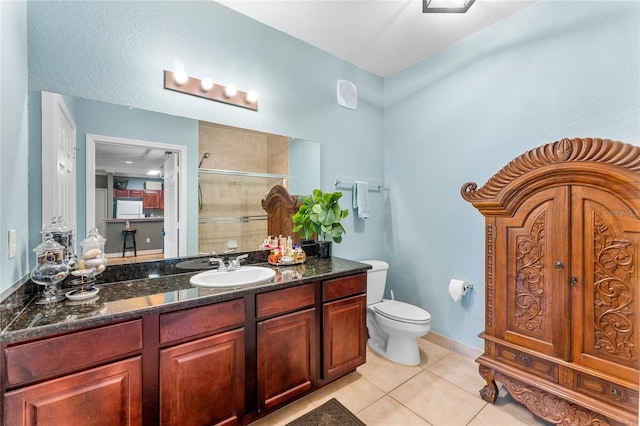 bathroom featuring vanity, tile patterned flooring, and toilet