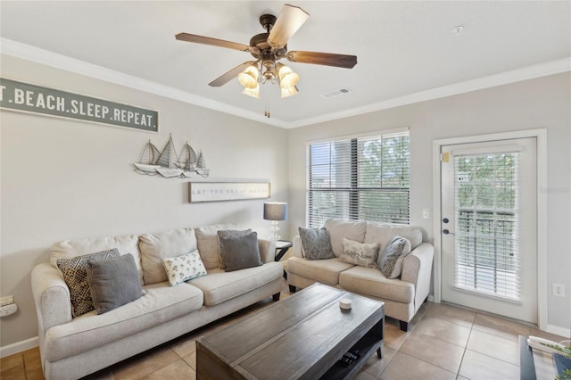 living room featuring light tile patterned floors, visible vents, baseboards, ceiling fan, and crown molding