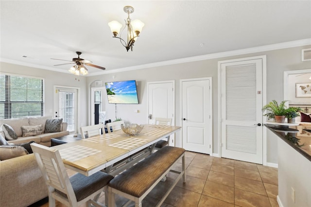 dining area featuring ceiling fan with notable chandelier, tile patterned flooring, visible vents, and crown molding