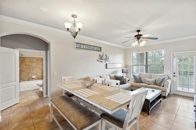 dining area with light tile patterned flooring, crown molding, a textured ceiling, and ceiling fan with notable chandelier