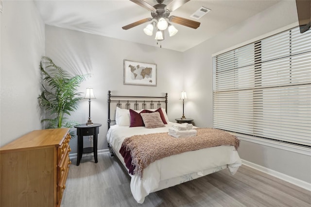 bedroom with wood-type flooring and ceiling fan